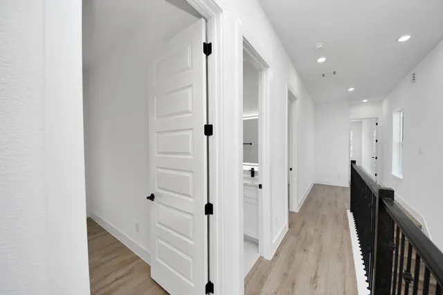 a view of hallway with wooden floor