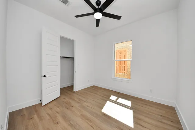 wooden floor in an empty room with a window