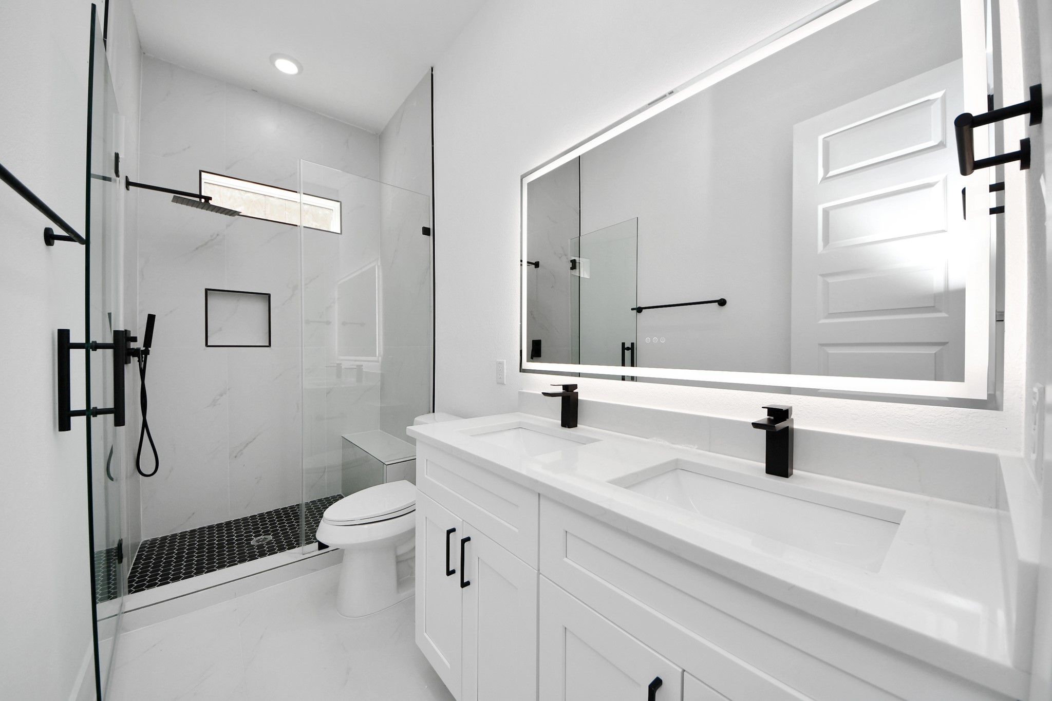 3310 Hardy Street Houston, TX 77009 - Photo 22 of 26 a bathroom with a sink a toilet a mirror and shower