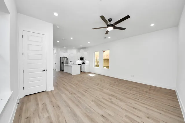 a view of a livingroom with a hardwood floor and a ceiling fan