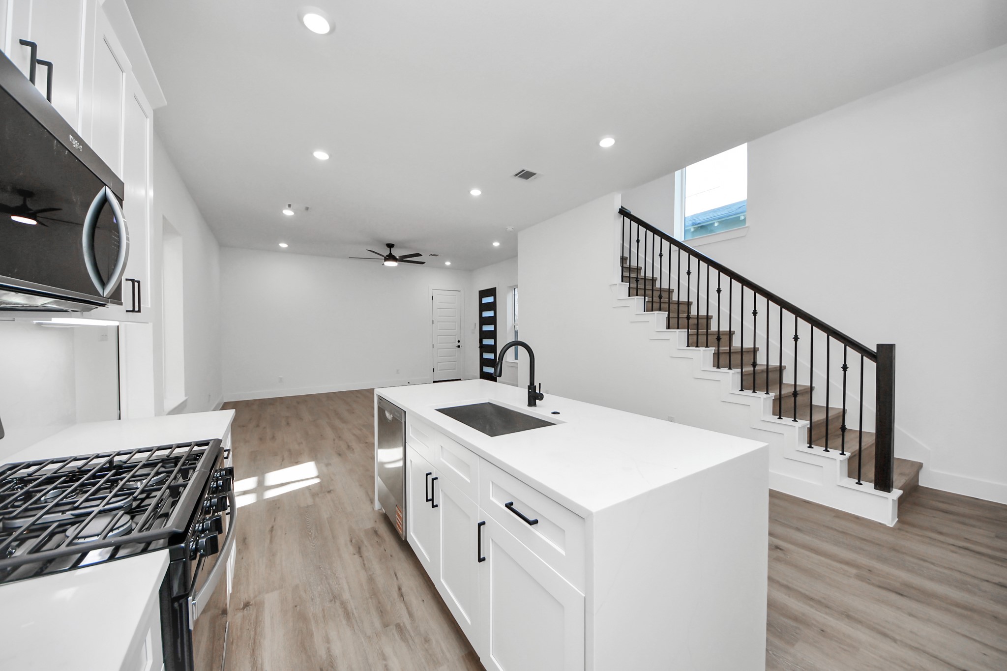 3310 Hardy Street Houston, TX 77009 - Photo 10 of 26 a kitchen with sink a stove and cabinets