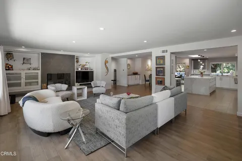 a dining room with furniture a chandelier and window
