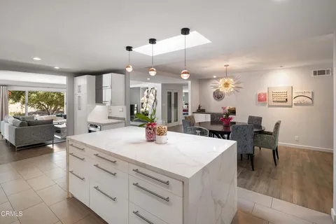 a bedroom with a large bed and a chair