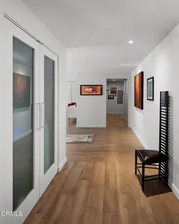 a bedroom with a bed and a flat screen tv on dresser