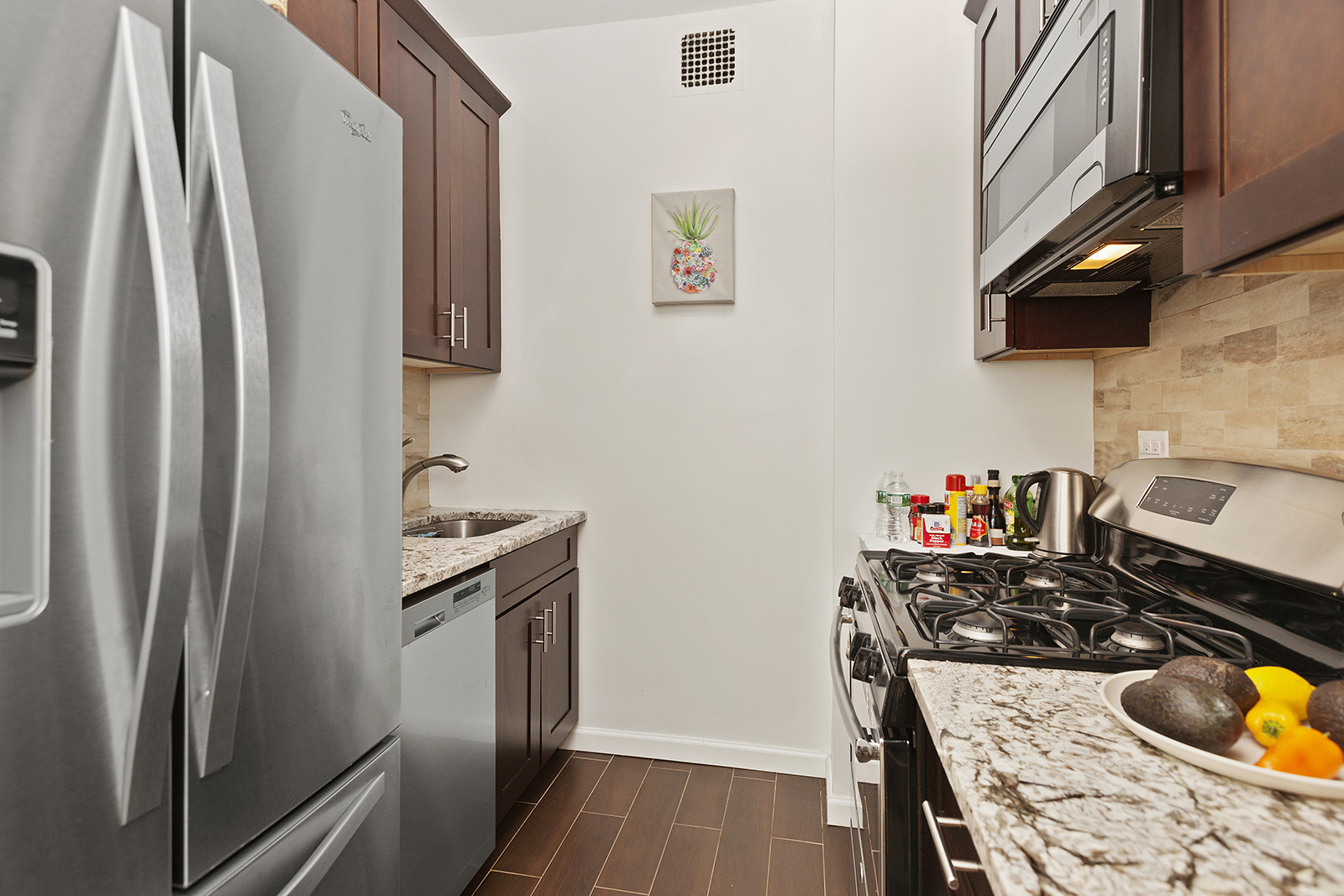 a kitchen with stainless steel appliances granite countertop a refrigerator and a stove