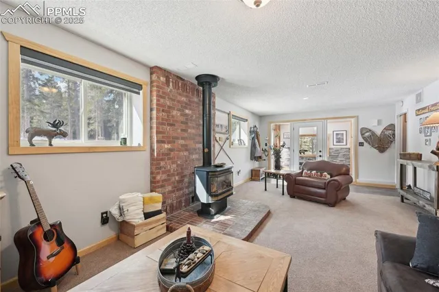 a view of a hallway with a glass door and furniture