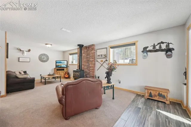 a bedroom with a bed dresser and a large window