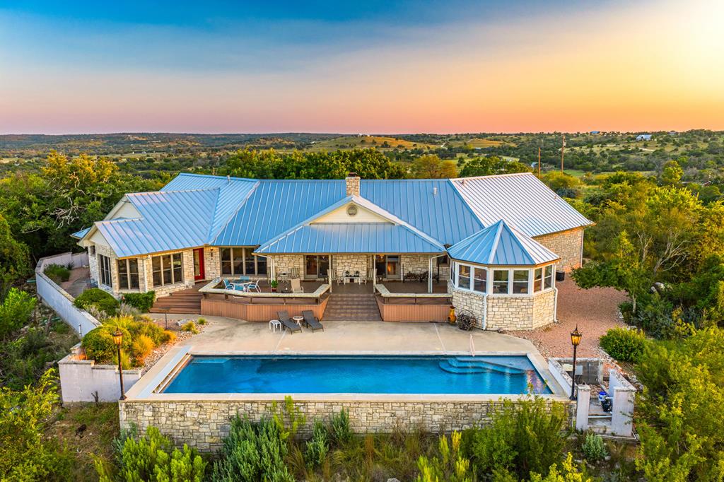 an aerial view of a house with balcony and outdoor space