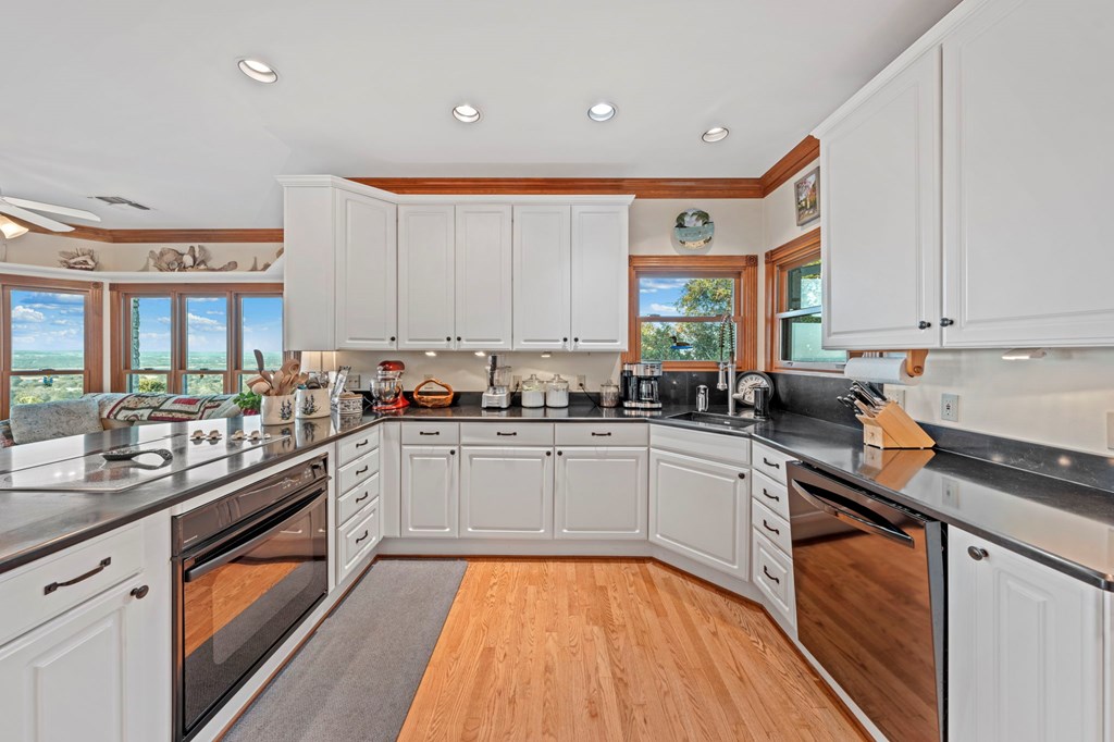 726 Paradise Ranch Road Fredericksburg, TX 78624 - Photo 12 of 38 a kitchen with a sink window and cabinets