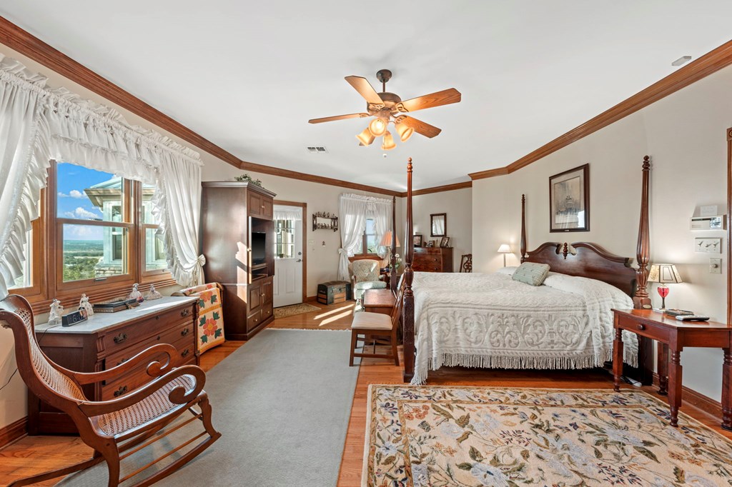 726 Paradise Ranch Road Fredericksburg, TX 78624 - Photo 13 of 38 a bedroom with furniture and a chandelier