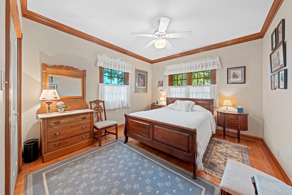 726 Paradise Ranch Road Fredericksburg, TX 78624 - Photo 20 of 38 a bedroom with a bed and a chandelier