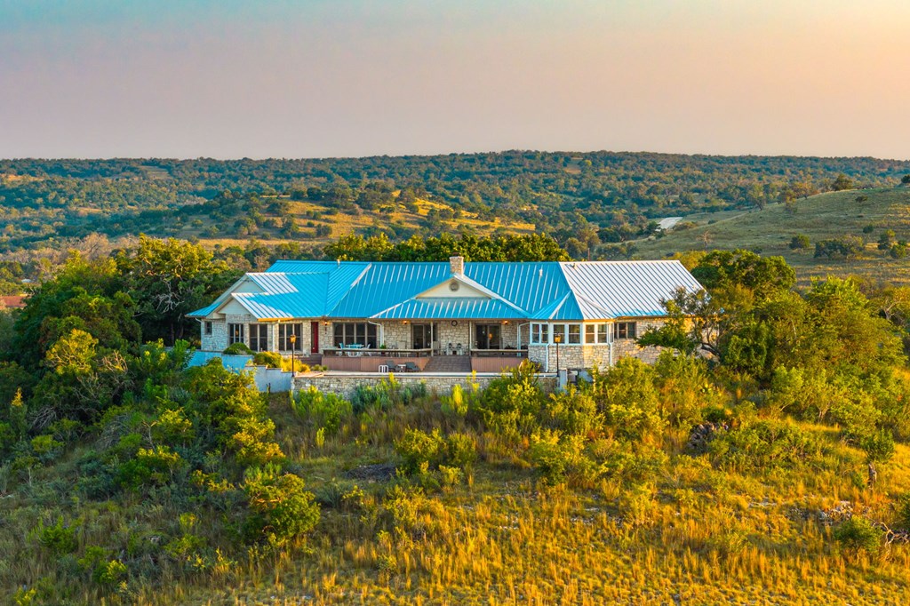726 Paradise Ranch Road Fredericksburg, TX 78624 - Photo 2 of 38 a view of a house with a yard and lake view