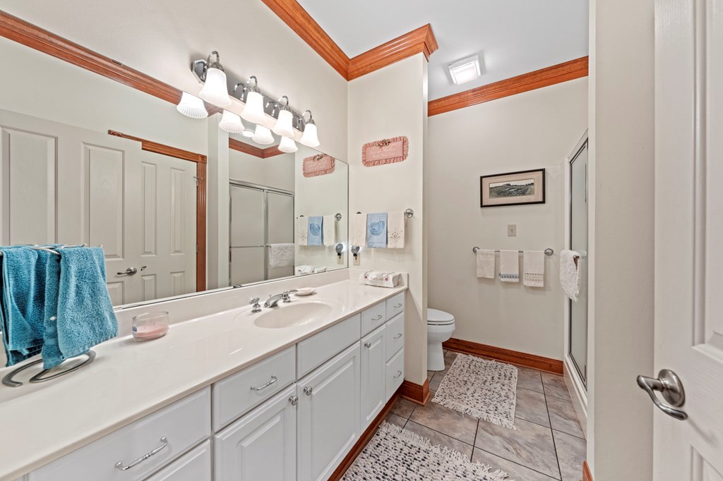 726 Paradise Ranch Road Fredericksburg, TX 78624 - Photo 22 of 38 a spacious bathroom with a double vanity sink a mirror and a shower