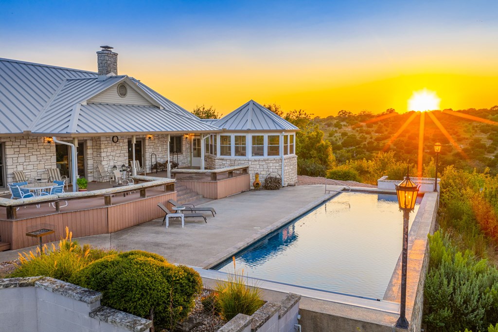 726 Paradise Ranch Road Fredericksburg, TX 78624 - Photo 28 of 38 a view of a house with pool and chairs