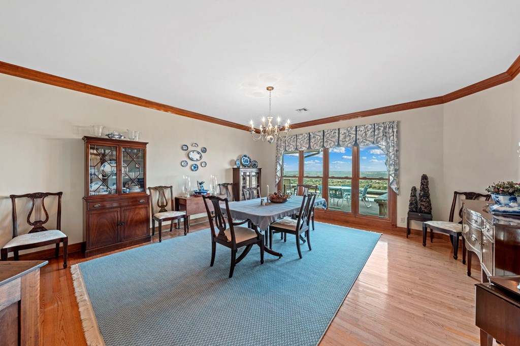 726 Paradise Ranch Road Fredericksburg, TX 78624 - Photo 9 of 38 a dining room with furniture and wooden floor
