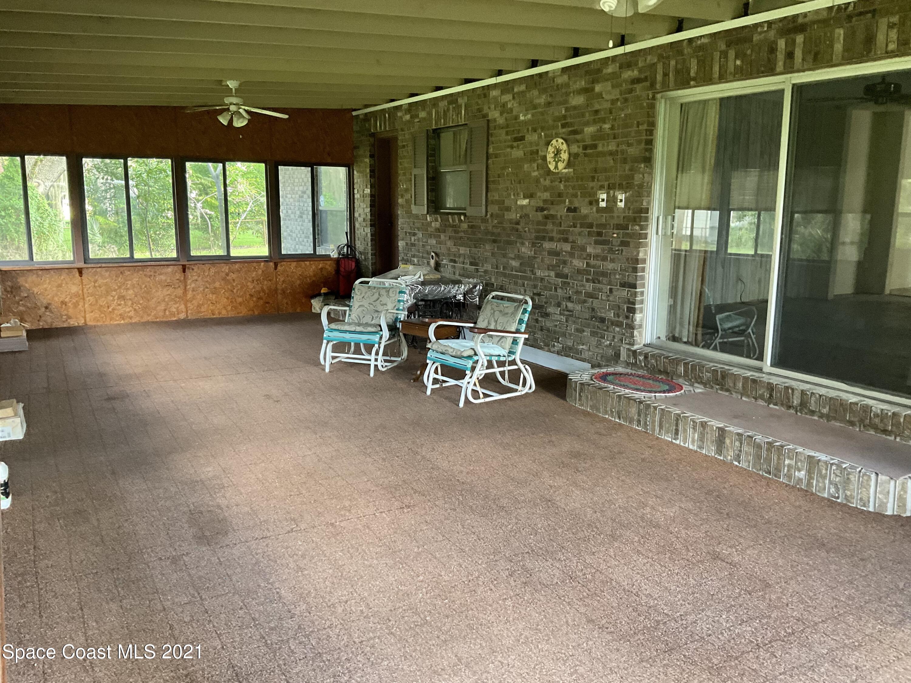 2580 Tammy Drive Mims, FL 32754 - Photo 15 of 47 a sitting area with swimming pool in front of it