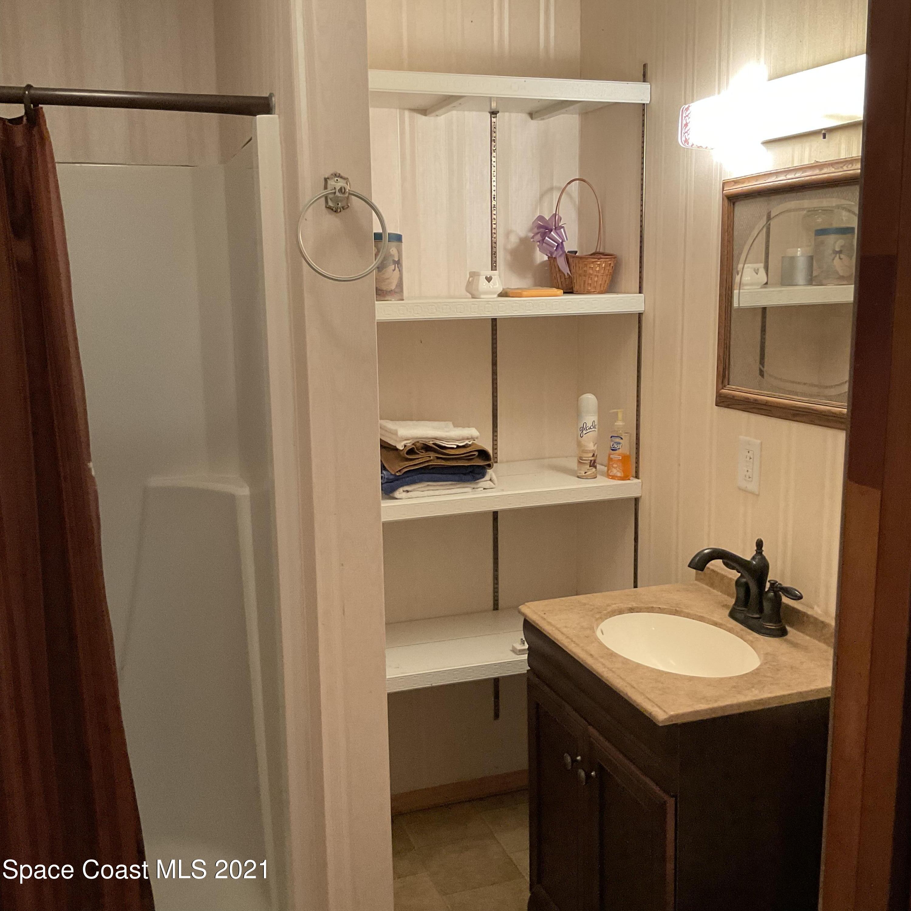 2580 Tammy Drive Mims, FL 32754 - Photo 17 of 47 a bathroom with a sink and a mirror