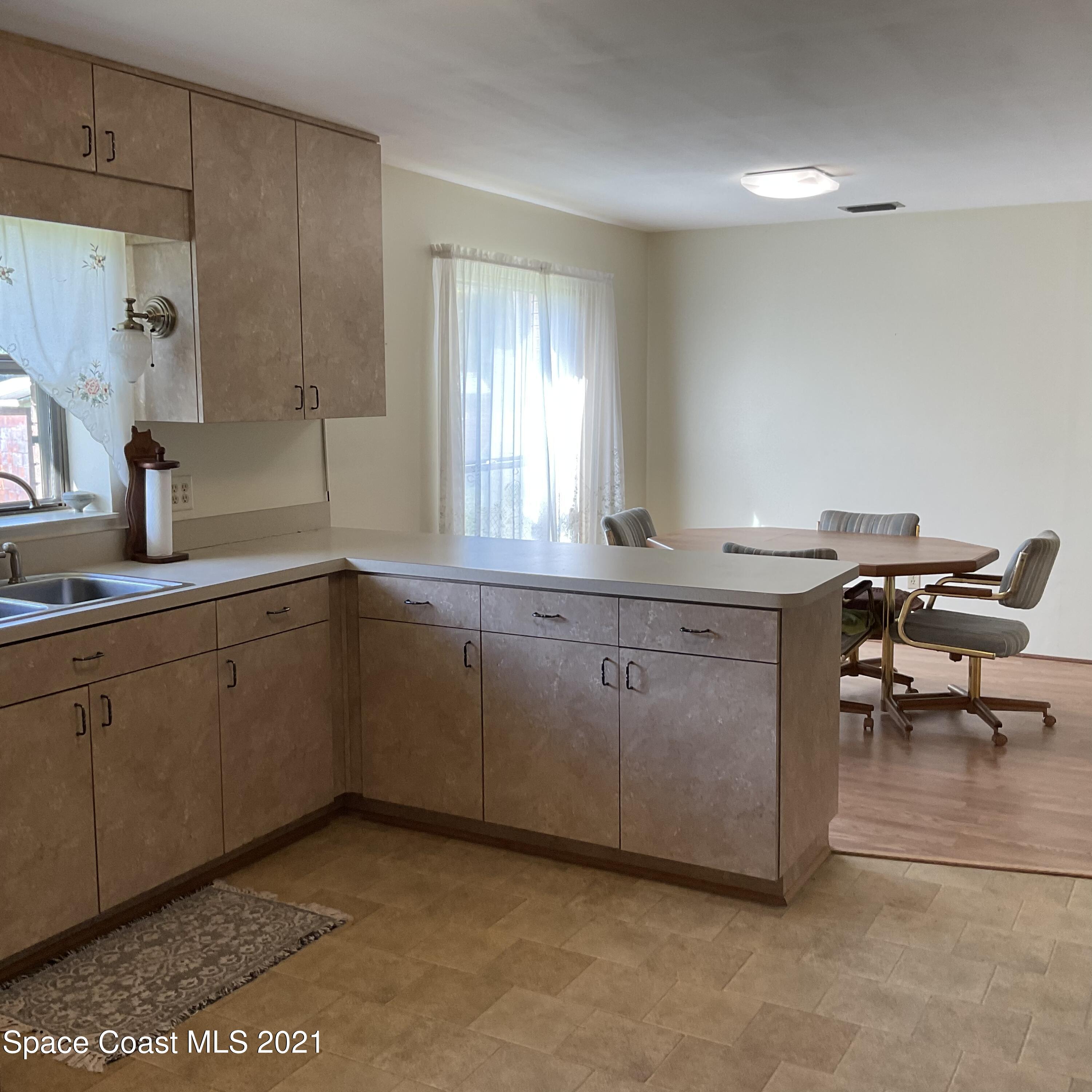 2580 Tammy Drive Mims, FL 32754 - Photo 18 of 47 a kitchen with a sink and cabinets