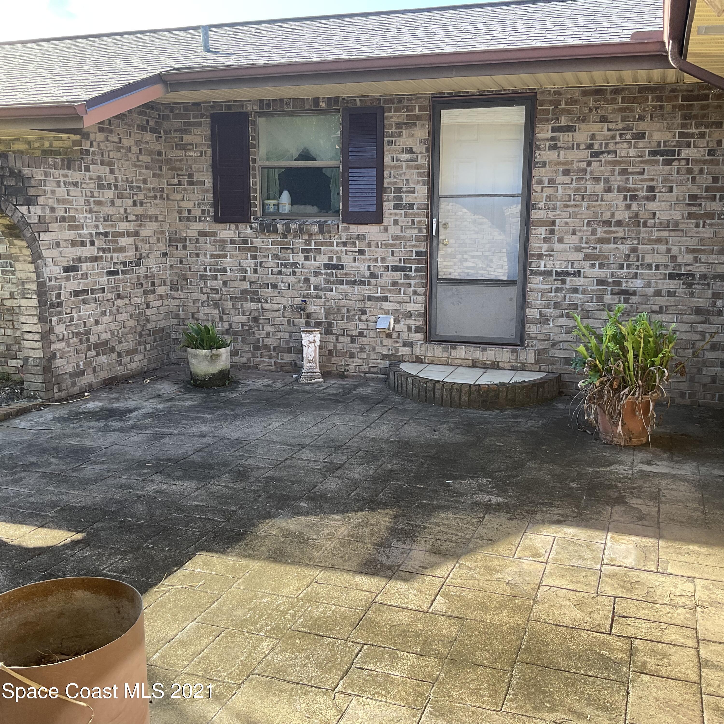 2580 Tammy Drive Mims, FL 32754 - Photo 24 of 47 a view of a brick house with a yard