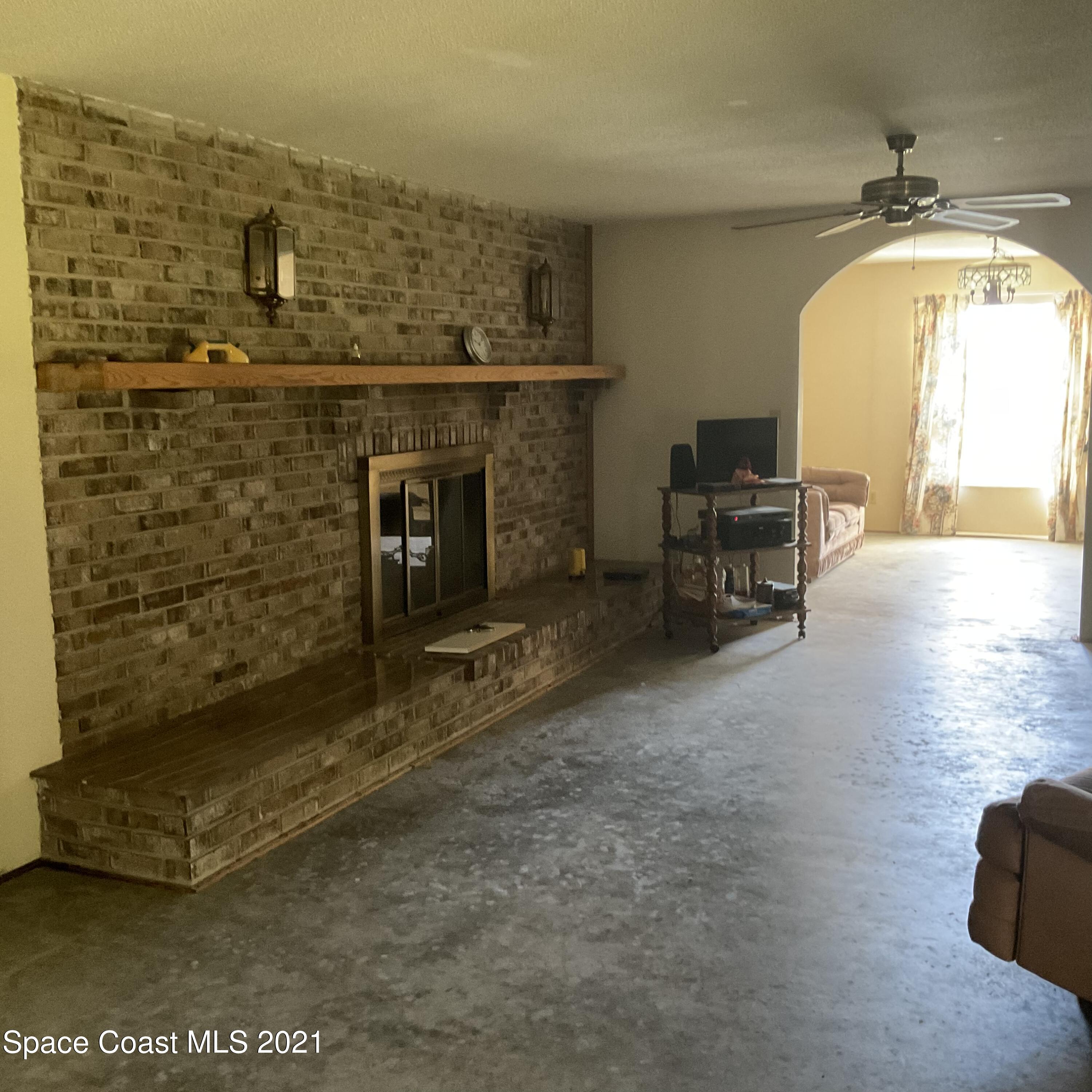 2580 Tammy Drive Mims, FL 32754 - Photo 25 of 47 a living room with a fireplace