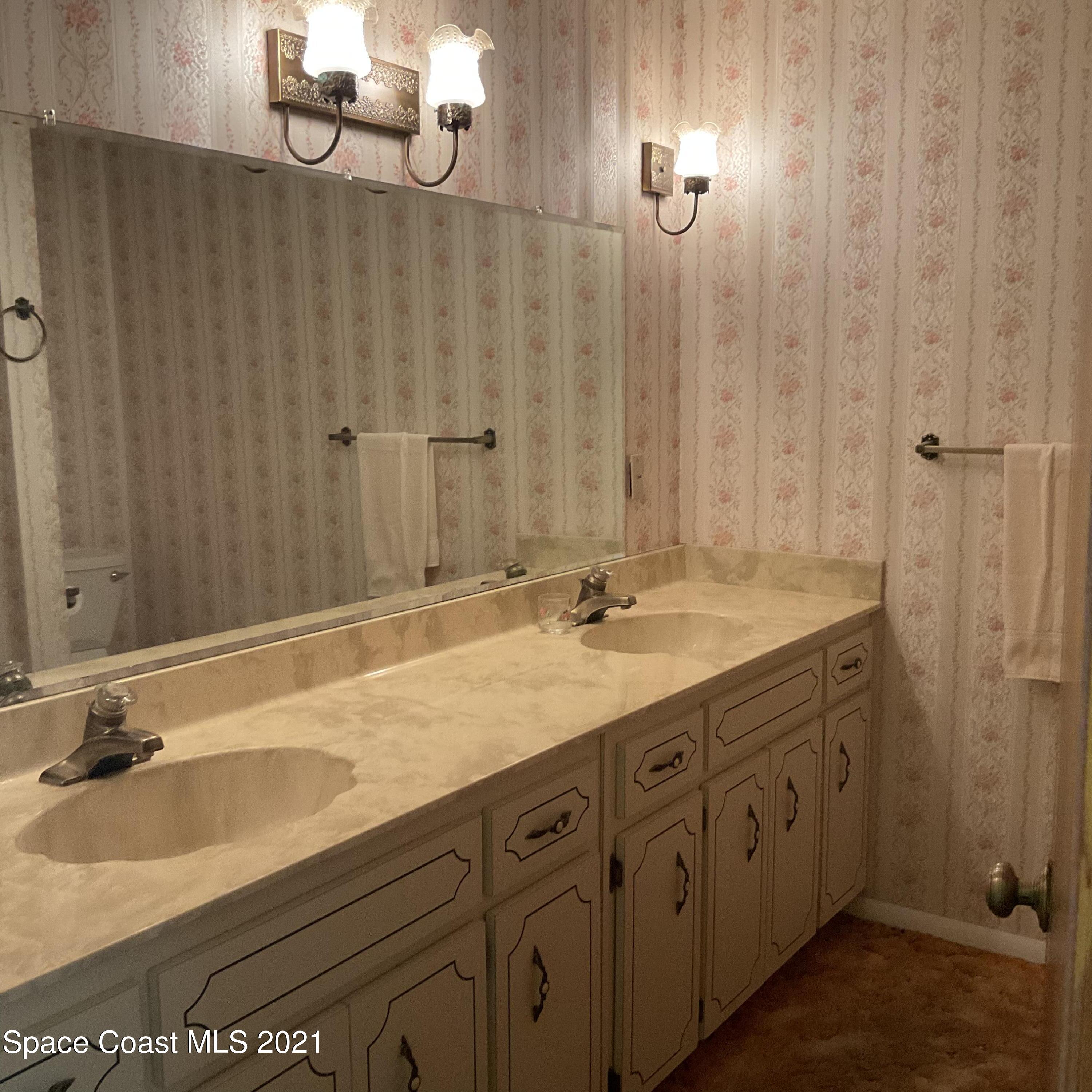 2580 Tammy Drive Mims, FL 32754 - Photo 32 of 47 a bathroom with a double vanity sink and a mirror