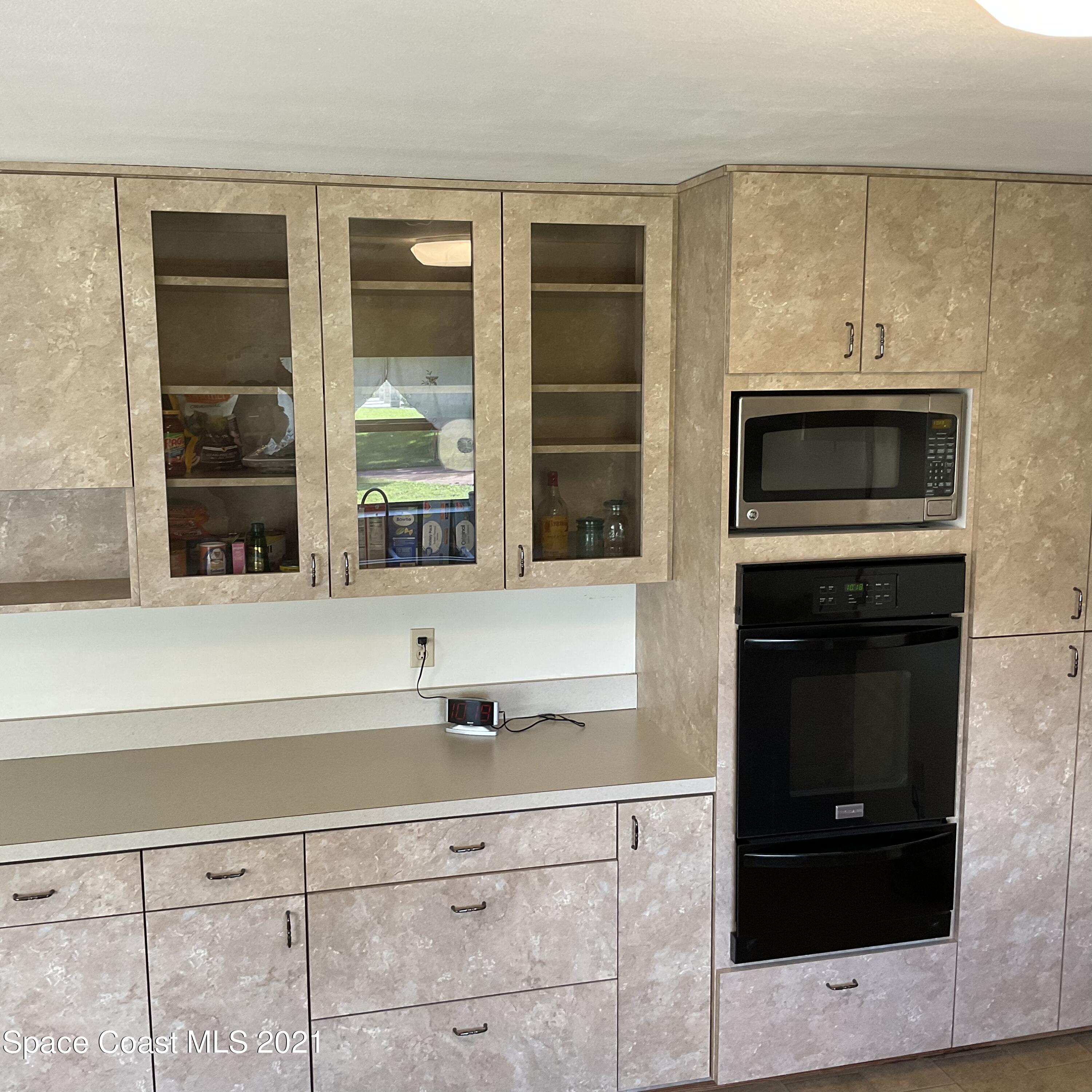2580 Tammy Drive Mims, FL 32754 - Photo 5 of 47 a kitchen with stainless steel appliances a stove and a microwave