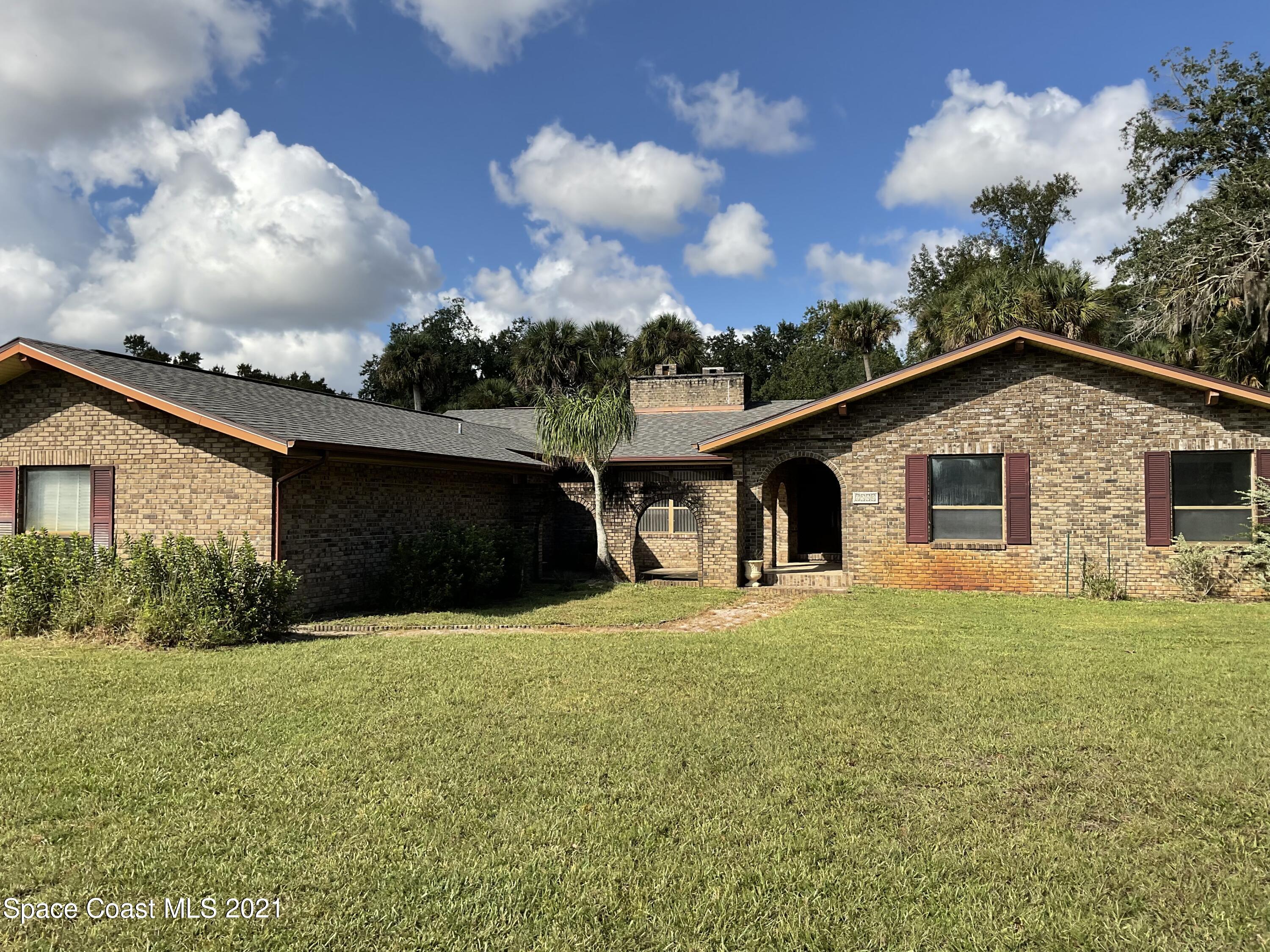 2580 Tammy Drive Mims, FL 32754 - Photo 45 of 47 a front view of house with yard and trees in the background