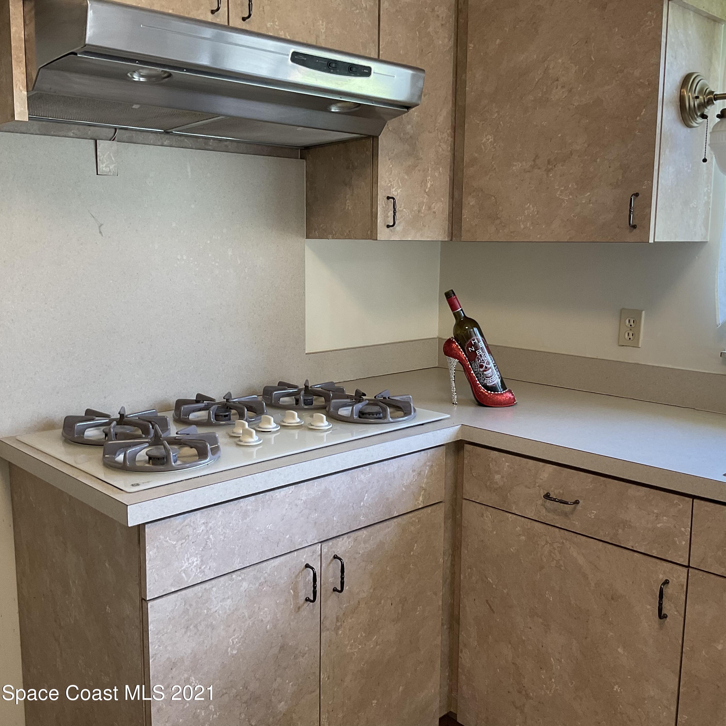 2580 Tammy Drive Mims, FL 32754 - Photo 6 of 47 a kitchen with a stove and cabinets