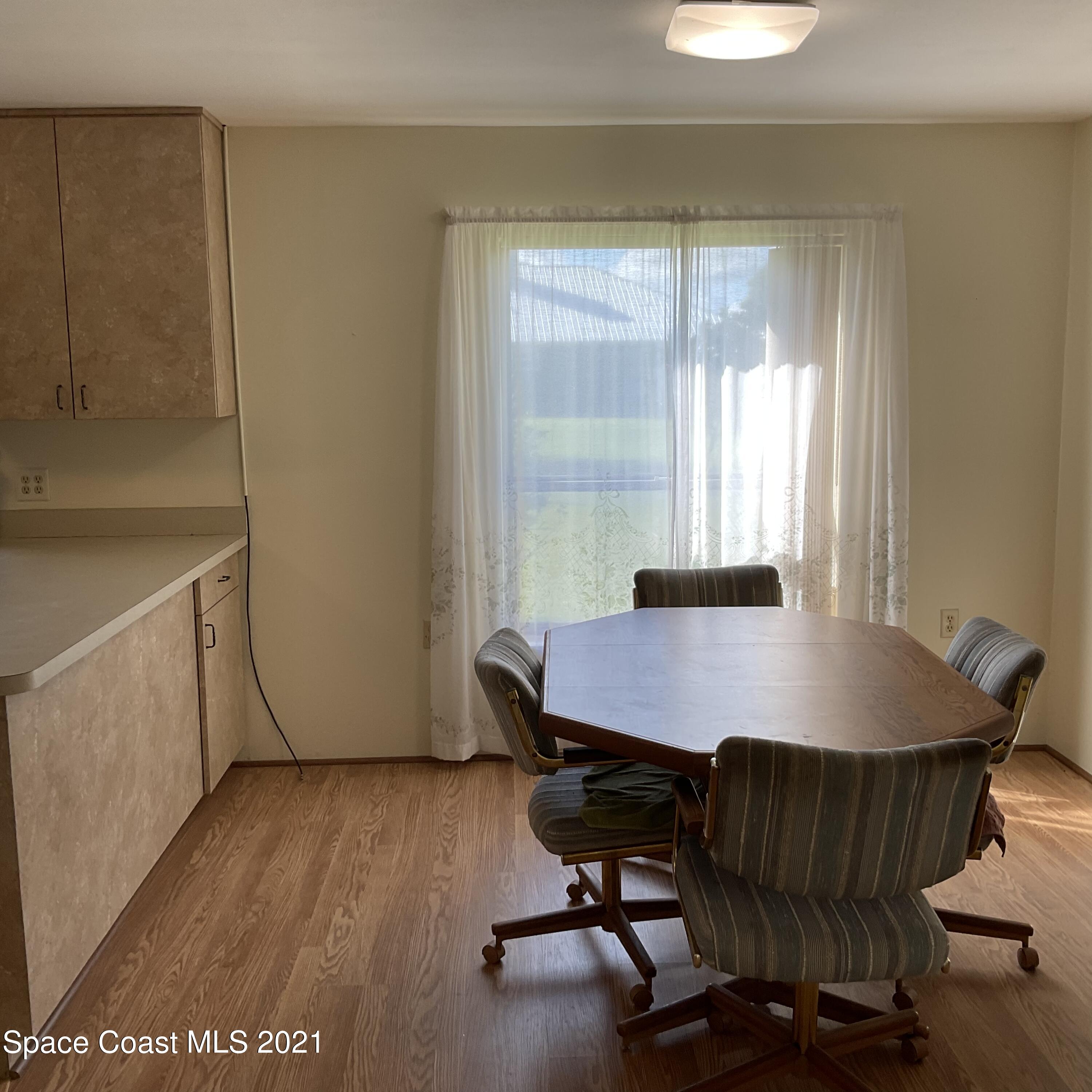 2580 Tammy Drive Mims, FL 32754 - Photo 7 of 47 a workspace with furniture and wooden floor