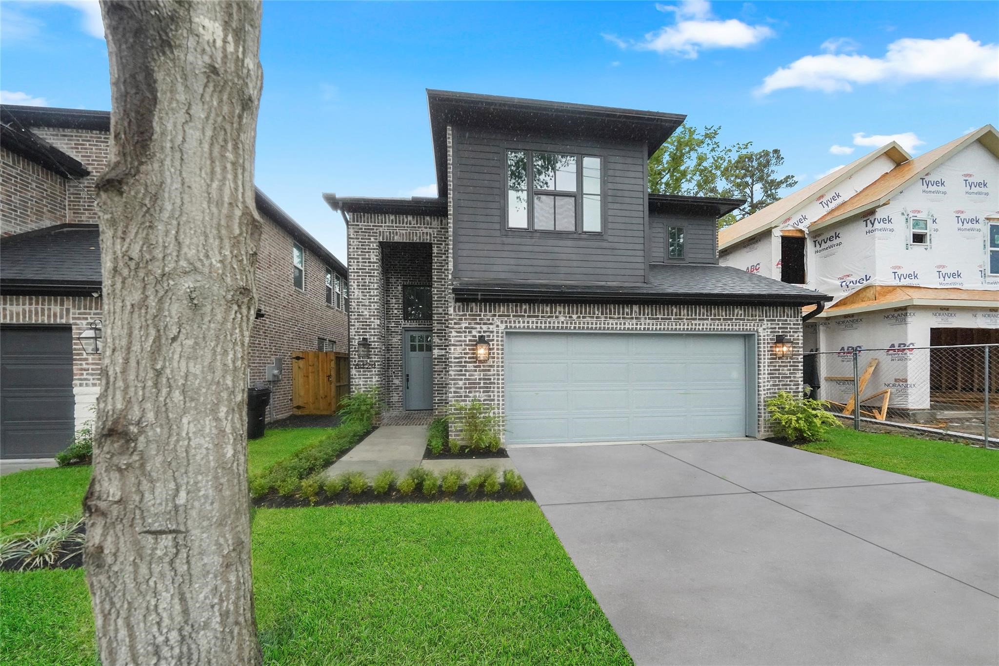 a front view of a house with a garden and yard
