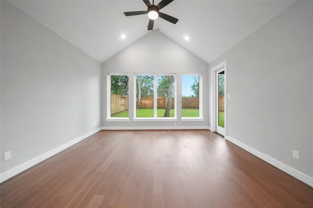 wooden floor in an empty room with a window