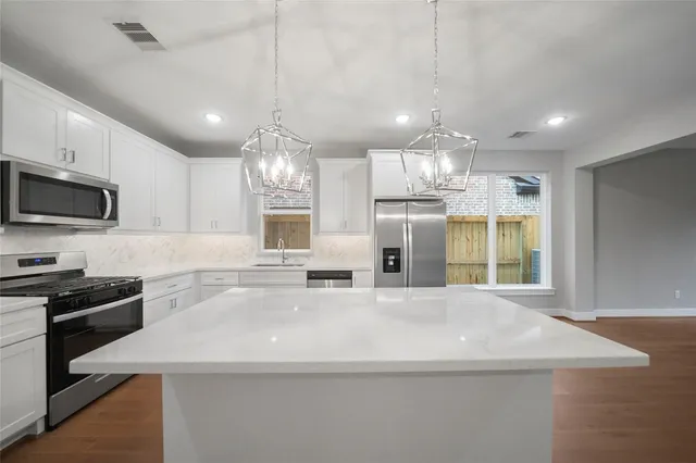 a kitchen with a sink stainless steel appliances and cabinets