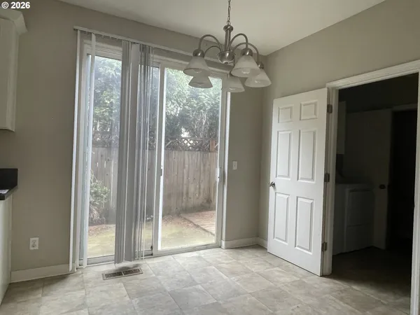 a view of a hallway with wooden floor and a dining room