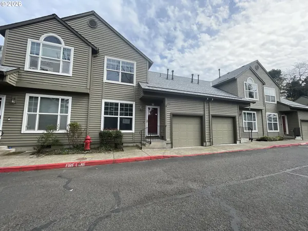 a front view of a house with a yard and a garage