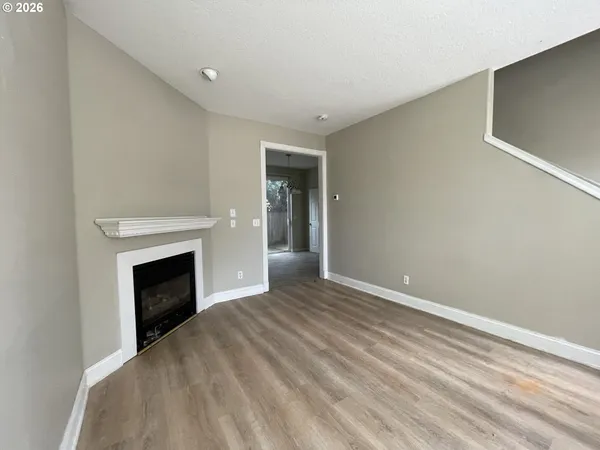 a view of an empty room with a fireplace