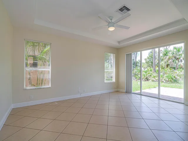 a view of a room with wooden floor and window