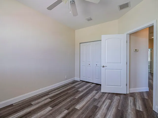 a utility room with granite countertop cabinets and sink