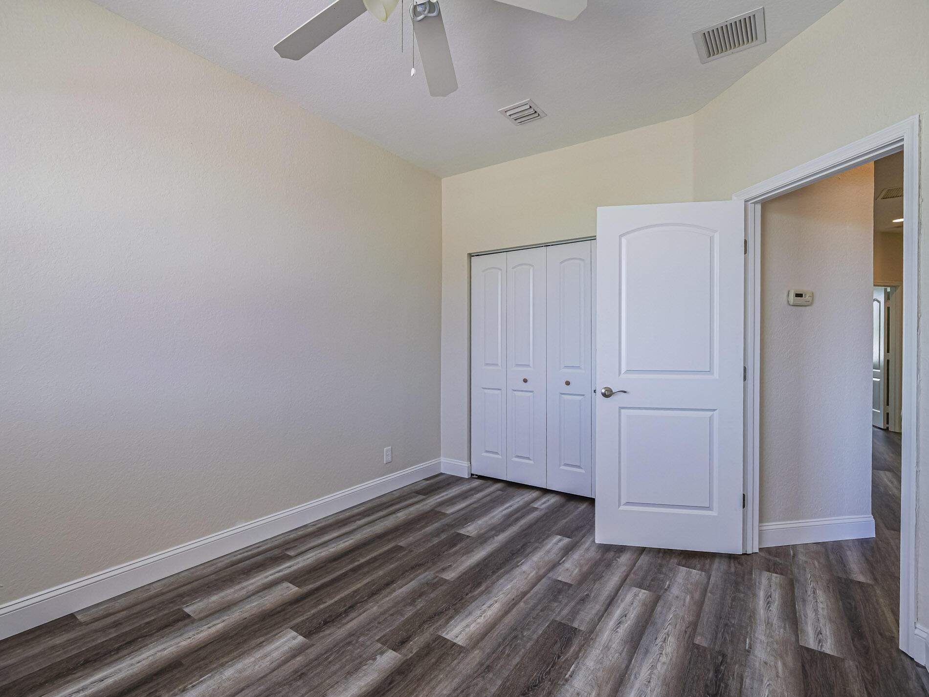 5605 Spanish River Road Fort Pierce, FL 34951 - Photo 34 of 40 a view of an empty room with wooden floor
