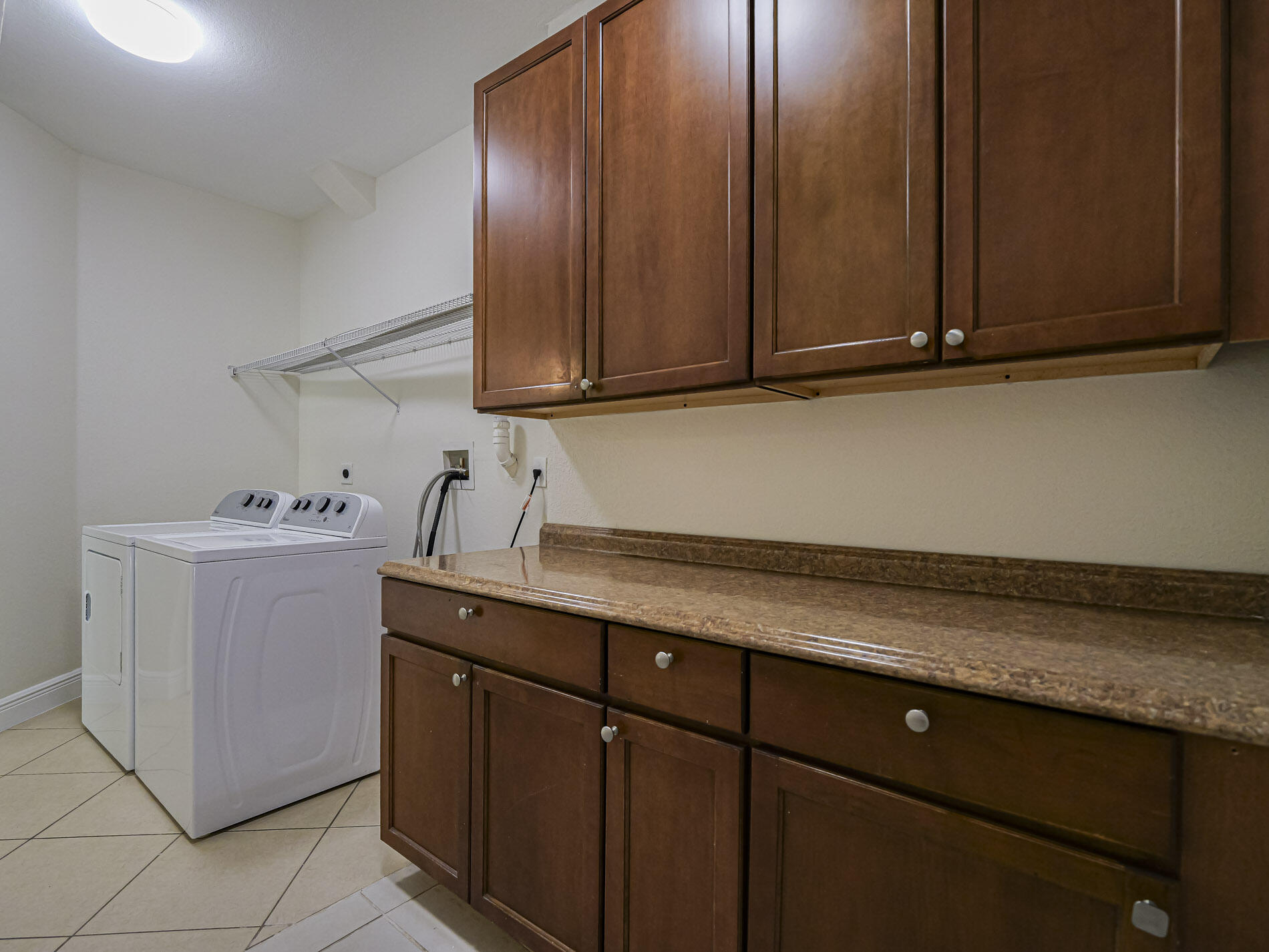 5605 Spanish River Road Fort Pierce, FL 34951 - Photo 36 of 40 a utility room with granite countertop cabinets and sink