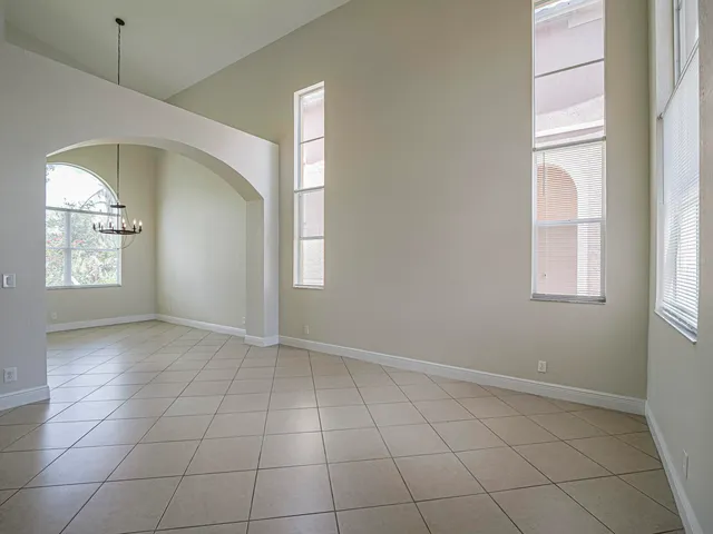 an empty room with windows and entrance
