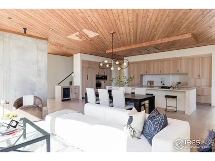 a living room with furniture and a kitchen view