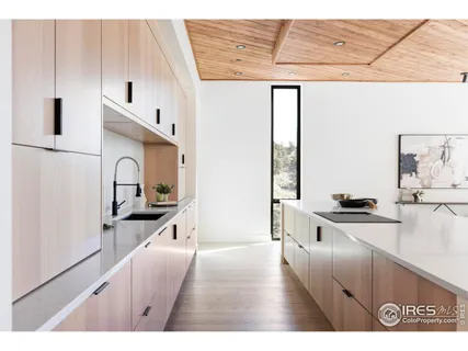 a kitchen with stainless steel appliances a sink a stove and white cabinets