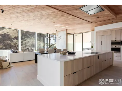 a large white kitchen with a large window