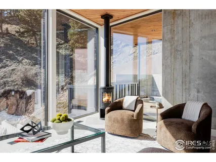 a living room with furniture and a floor to ceiling window