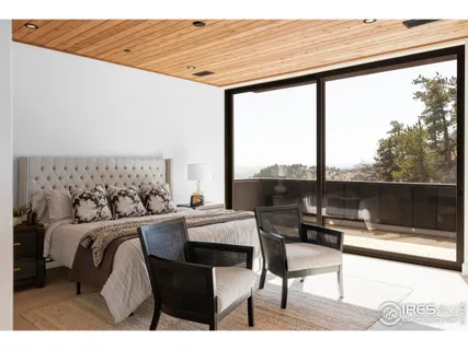 a bedroom with a bed a table and chair