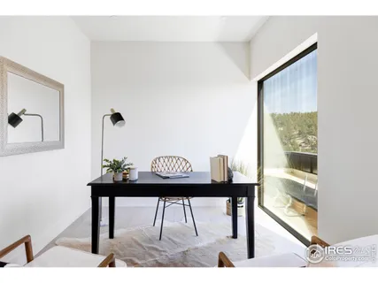 a view of a room with a table and chairs