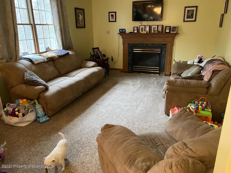 309 Church Road Mountain Top, PA 18707 - Photo 8 of 48 a living room with furniture a flat screen tv and a fireplace