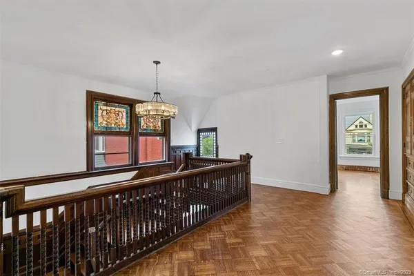 a view of entryway and hall with wooden floor