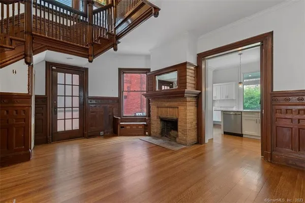 a view of a livingroom with a fireplace and wooden floor