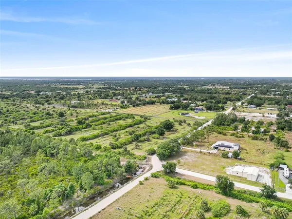 an aerial view of residential houses with city view